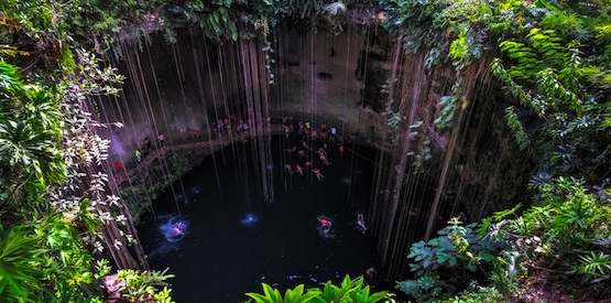 Cenote cave lake with people swimming, Chichen Itza, Mexico